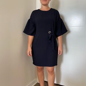 Navy lose dress with puffy sleeves and tie detail